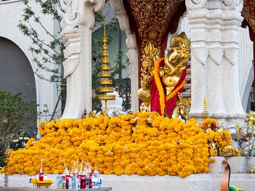 Photography The Ganesha Shrine with yellow flowers, Phuang Malai, at the centralwOrld (Central World) shopping mall in Bangkok, Thailand