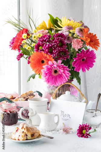 A beautiful Mother's Day flower arrangement with a card, tea and scones,