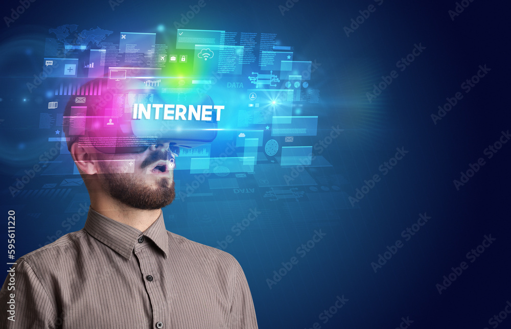 Businessman looking through Virtual Reality glasses Businessman looking through Virtual Reality glasses