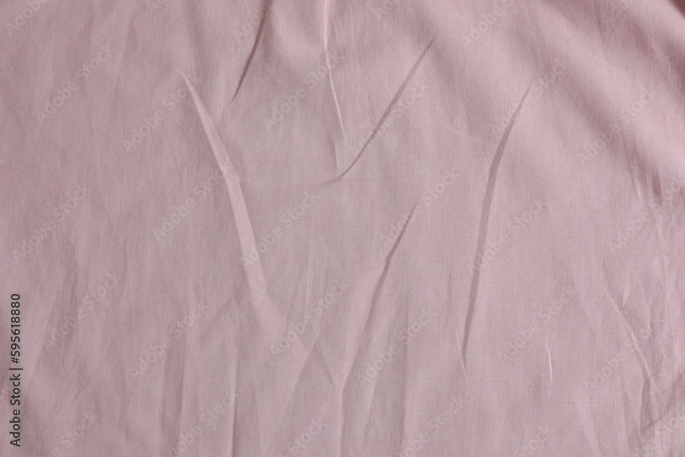 Crumpled pink fabric as background, top view Crumpled pink fabric as background, top view