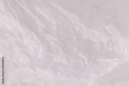 Crumpled transparent plastic bag as background, top view