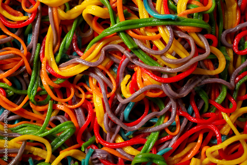 Spaghetti painted with different food colorings as background  top view