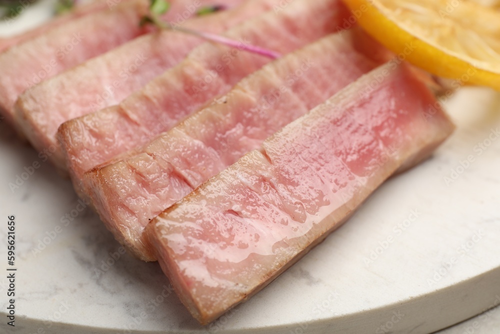 Pieces of delicious tuna steak on serving board, closeup Pieces of delicious tuna steak on serving board, closeup