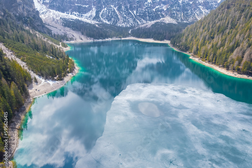 Panoramic shot from a naturpark fanes sennes. Ice on Braies Lake, view from above. Spring view of Italian Alps photo