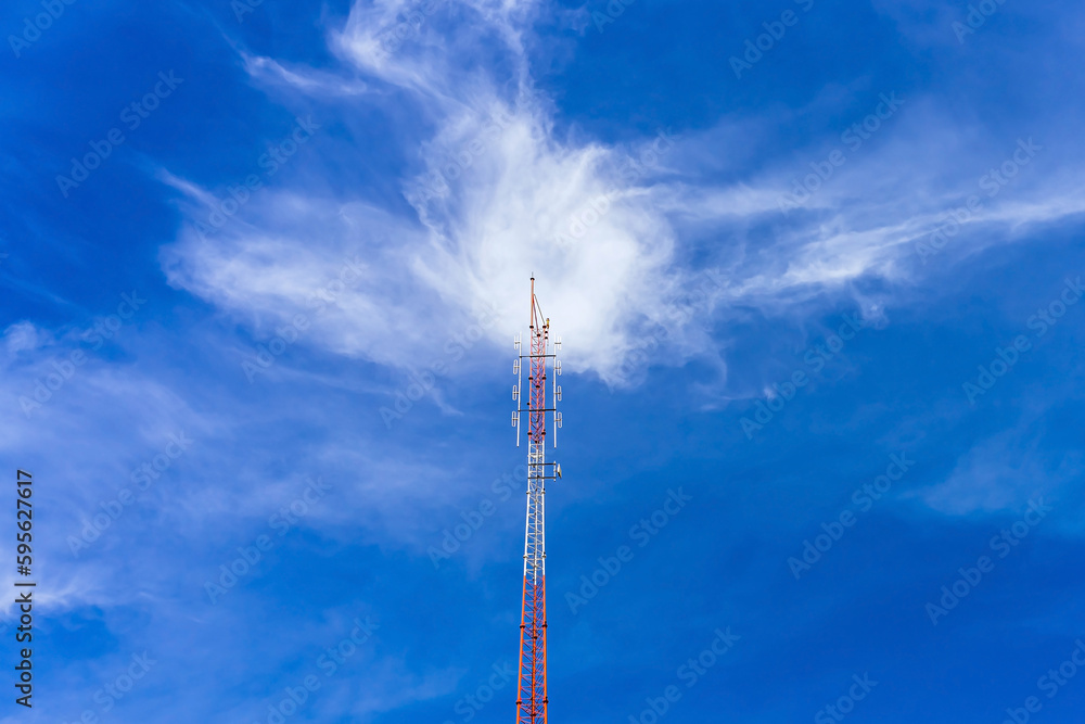 Telecommunication radio wave signal tower red and white with cloudy. Steel truss of transmission signal antenna with blue sky. Telecommunication tower, Global connection and internet network concept. Telecommunication radio wave signal tower red and white with cloudy. Steel truss of transmission signal antenna with blue sky. Telecommunication tower, Global connection and internet network concept.