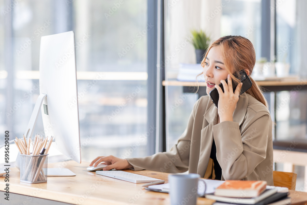 Cheerful business Asian woman freelancer making telephone call share good news about project working in office workplace, business finance concept. Cheerful business Asian woman freelancer making telephone call share good news about project working in office workplace, business finance concept.