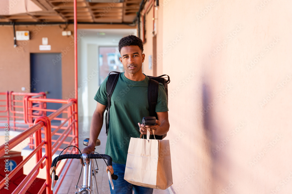 Young man delivering food at home Young man delivering food at home