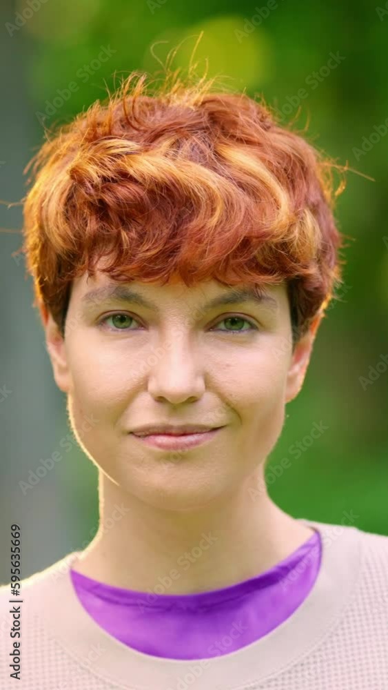 Smiling non-binary person looking at the camera outdoors Smiling non-binary person looking at the camera outdoors