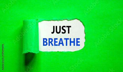 Just breathe and psychological symbol. Concept words Just breathe on beautiful white paper. Beautiful green table green background. Business psychological and Just breathe concept. Copy space