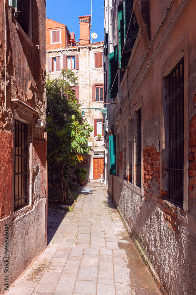 Old narrow street in the historical part of Venice.
