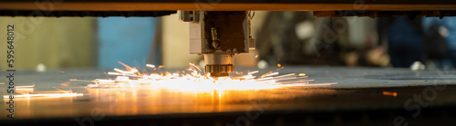 Canvas Print CNC machine. Laser cutting of metal. Sparks. Widescreen.