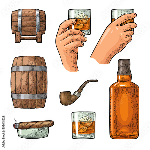 Whiskey glass with ice cubes, barrel, bottle
