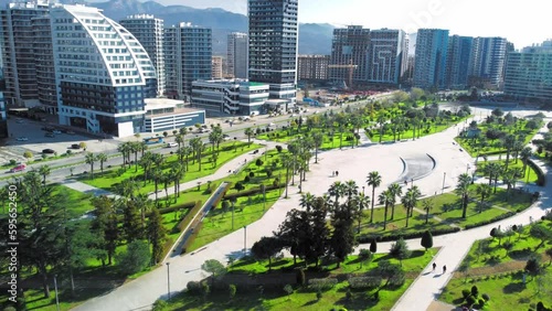Resort town of Batumi in Georgia. Aerial view of green park on sunny day against background of sea. Lehi and Maria Kaczynski Park in city. Beautiful green landscaping. Infrastructure, mountains photo