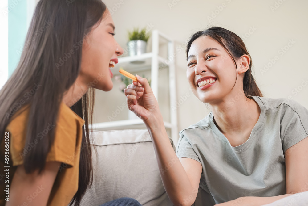 Happy lesbian, pleasure two asian young women, girl gay or close friend, couple love , moment spending good time together on sofa at home. Activity of leisure, relax. Happy lesbian, pleasure two asian young women, girl gay or close friend, couple love , moment spending good time together on sofa at home. Activity of leisure, relax.