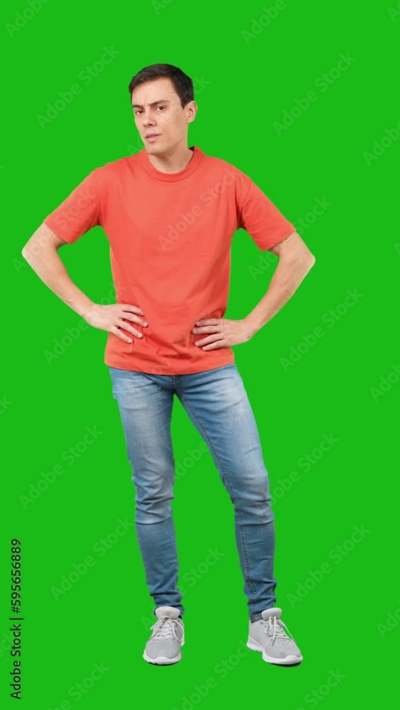 Bored male with crossed arms against green background Bored male with crossed arms against green background