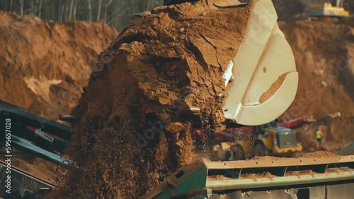 Conveyor for sand production in the quarry. Heavy machinery working on quarry with equipment for production of building materials such as gravel and sand