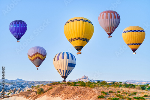 Landscape of colorful flying hot air balloons in Anatolia, Kapadokya at sunrise. National park in Nevsehir, Goreme