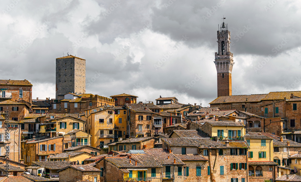 Beautiful generic architecture with buildings and towers under cloudy sky in Siena, Firenze, Italy. Travel destinations Europe