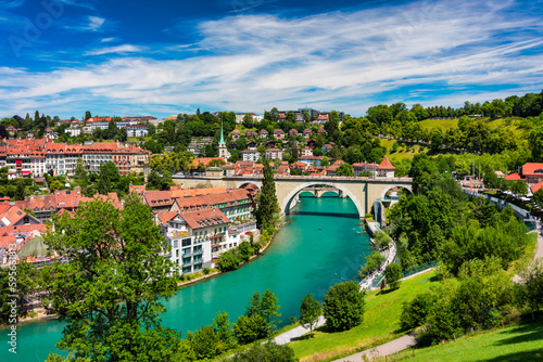 View of the Bern old city center and Nydeggbrucke bridge over river Aare, Bern, Switzerland. Bern old town with the Aare river flowing around the town on a sunny day, Bern, Switzerland. photo
