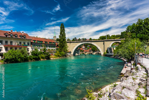 View of the Bern old city center and Nydeggbrucke bridge over river Aare, Bern, Switzerland. Bern old town with the Aare river flowing around the town on a sunny day, Bern, Switzerland. © daliu