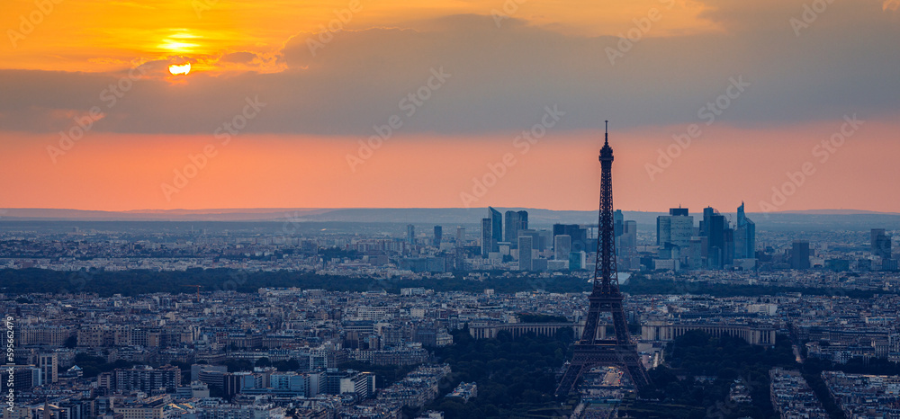 Fototapeta premium View of Paris with Eiffel Tower from Montparnasse building. Eiffel tower view from Montparnasse at sunset, view of the Eiffel Tower and La Defense district in Paris, France.