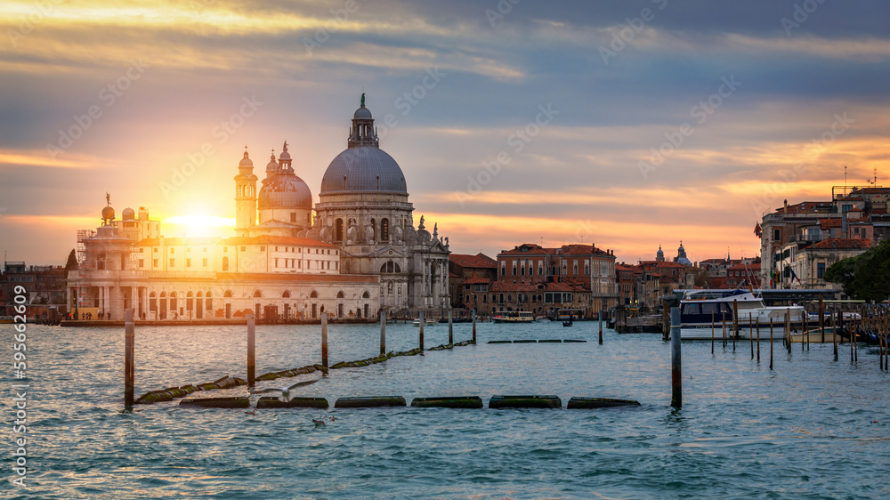 Sunset in Venice. Image of Grand Canal in Venice, with Santa Maria della Salute Basilica in the background. Venice is a popular tourist destination of Europe. Venice, Italy.