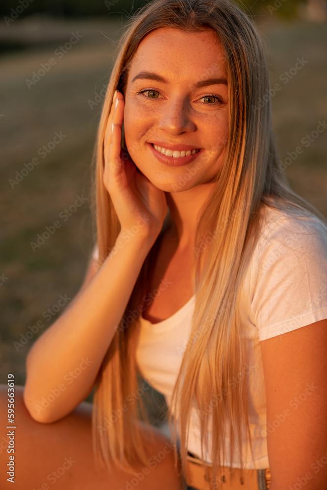 Beautiful happy young woman in the park on a warm summer day Beautiful happy young woman in the park on a warm summer day