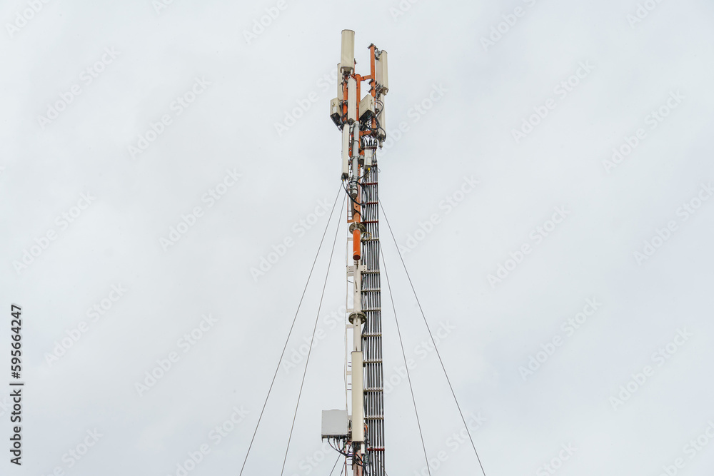 New GSM antennas on a tower against a blue sky for transmitting a 5g signal are dangerous. Radiation pollution of the environment through cell towers. New technologies in the field of communication. New GSM antennas on a tower against a blue sky for transmitting a 5g signal are dangerous. Radiation pollution of the environment through cell towers. New technologies in the field of communication.