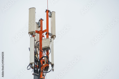 New GSM antennas on a tower against a blue sky for transmitting a 5g signal are dangerous. Radiation pollution of the environment through cell towers. New technologies in the field of communication.