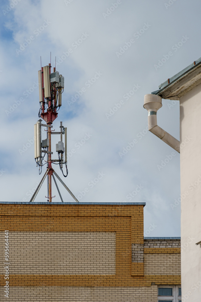 New GSM antennas on the roof of a residential building in the city for transmitting a 5g signal are a danger to human health. Radiation pollution of the environment through cell towers.