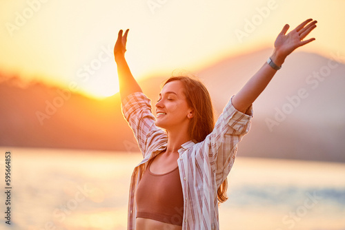 Canvas-taulu Portrait of calm happy smiling free woman with open arms and closed eyes enjoys