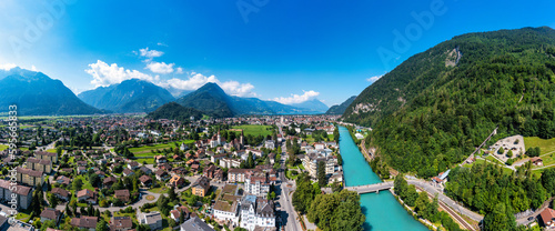 Aerial view over the city of Interlaken in Switzerland. Beautiful view of Interlaken town, Eiger, Monch and Jungfrau mountains and of Lake Thun and Brienz. Interlaken, Bernese Oberland, Switzerland.
