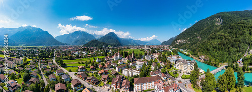 Aerial view over the city of Interlaken in Switzerland. Beautiful view of Interlaken town, Eiger, Monch and Jungfrau mountains and of Lake Thun and Brienz. Interlaken, Bernese Oberland, Switzerland. © daliu