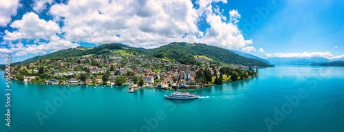 Oberhofen panoramic view at Lake Thunersee in swiss Alps, Switzerland. Town of Oberhofen on the Lake Thun (Thunersee) in Bern Canton of Switzerland. Oberhofen town on Lake Thun, Switzerland.