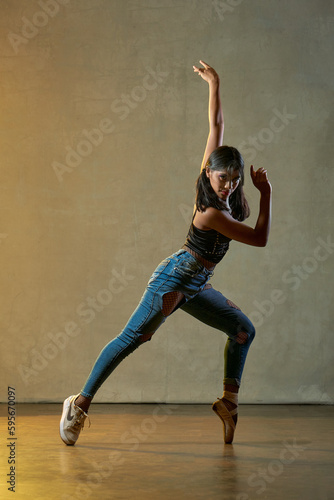 young beautiful ballerina posing and dancing in a studio 