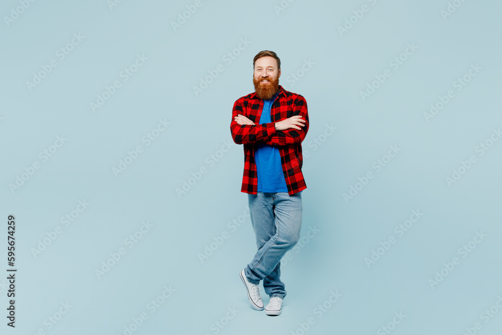 Full body smiling happy young redhead bearded man he wear casual clothes look camera hold hands crossed folded isolated on plain pastel light blue cyan background studio portrait. Lifestyle concept. Full body smiling happy young redhead bearded man he wear casual clothes look camera hold hands crossed folded isolated on plain pastel light blue cyan background studio portrait. Lifestyle concept.