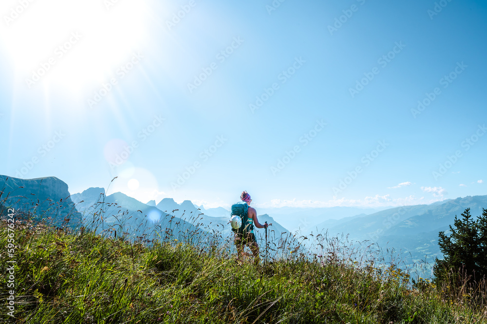 Obraz premium Young woman enjoys the view from a vantage point on the Walensee in the morning. Schnürliweg, Walensee, St. Gallen, Switzerland, Europe.