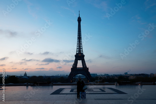 Unidentified couple in front of world famous Eiffel Tower. Paris.