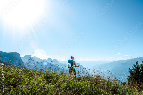Young woman enjoys the view from a vantage point on the Walensee in the morning. Schnürliweg, Walensee, St. Gallen, Switzerland, Europe.