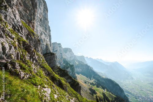 Amazing view on the Churfürsten mountain range from hike trail below steep rock wall. Schnürliweg, Walensee, St. Gallen, Switzerland, Europe. photo