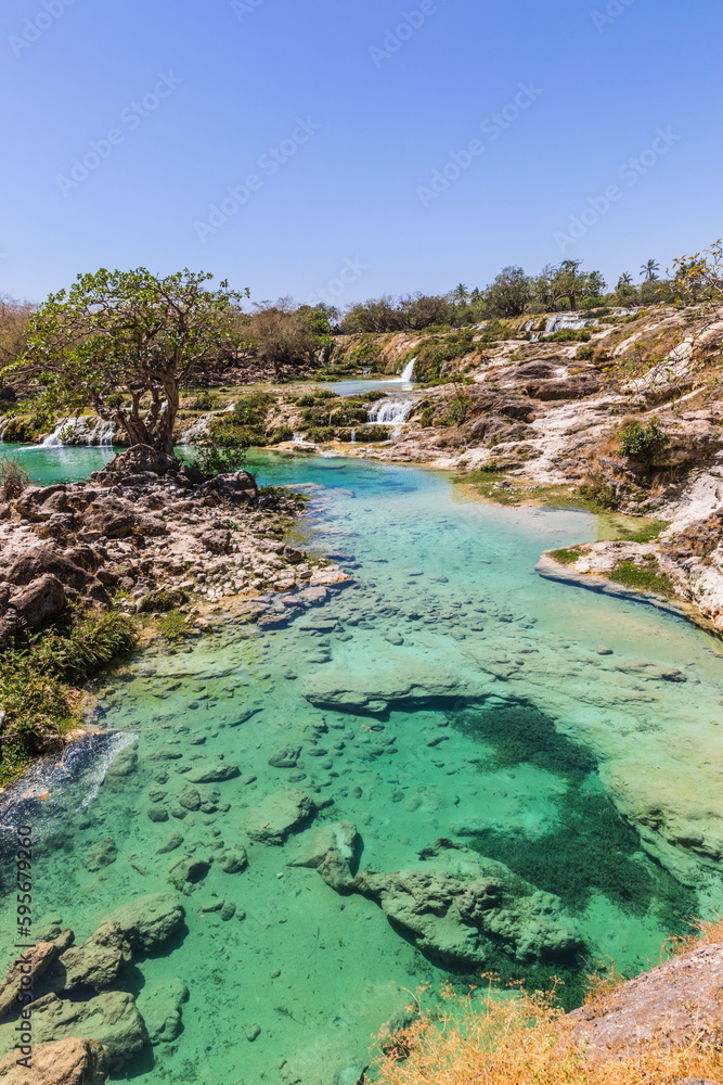Obraz premium Wadi Darbat Valley, one of the most beautiful and picturesque places of nature in the Dhofar region in the Sultanate of Oman.