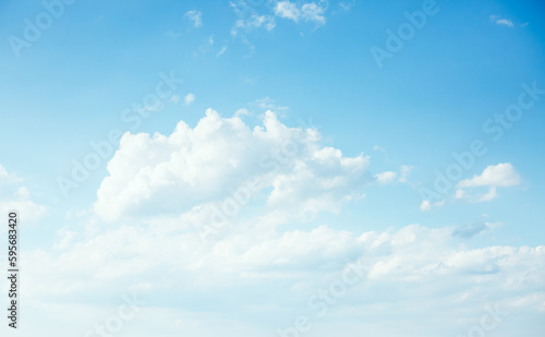 Gorgeous sky background with white fluffy clouds in the sunny day.