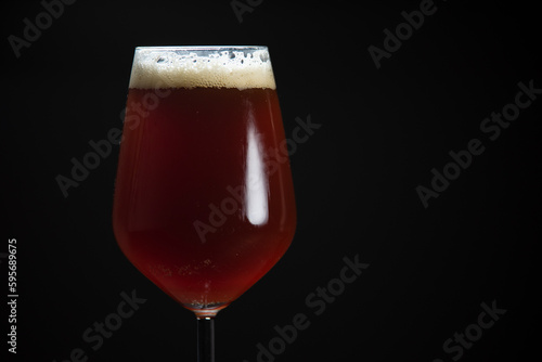 A glass of delicious craft beer served on an authentic beer glass, to be used as a background