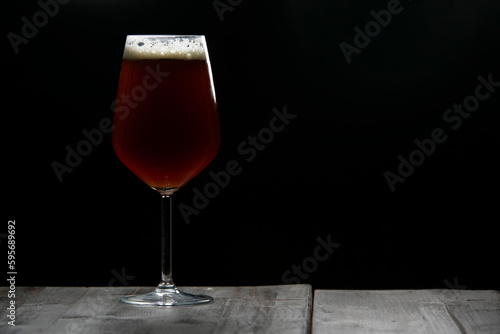 A glass of delicious craft beer served on an authentic beer glass, to be used as a background