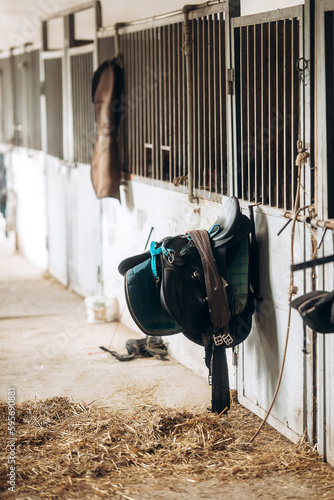 Leather black horse saddle in barn