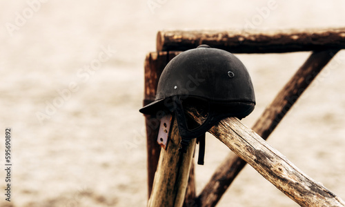 riding helmet on a wooden fence. horse jockey equipment