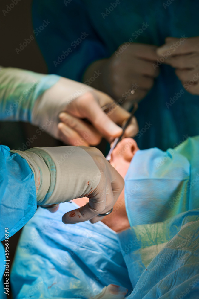 surgical instruments in the hands of a doctor close-up surgical instruments in the hands of a doctor close-up