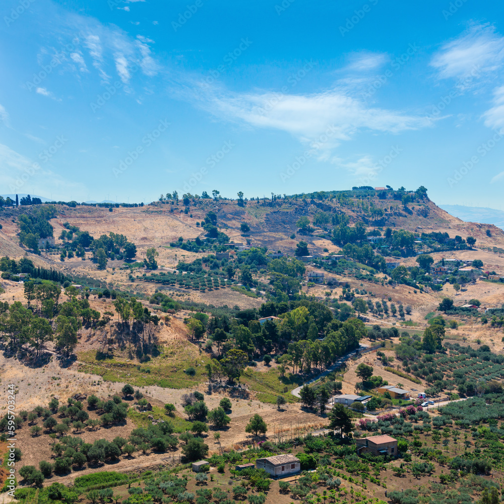 View to road, gardens and mountain from famous ancient ruins in Valley of Temples, Agrigento, Sicily, Italy.