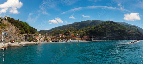 Beautiful summer Monterosso view from excursion ship. One of five famous villages of Cinque Terre National Park in Liguria, Italy. People unrecognizable.