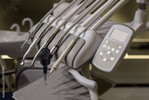 Modern dental unit, instruments and devices for teeth treatment in the dentist's office in close-up. Various tips, ultrasonic scaler, surgical, endo and periodontal tips.